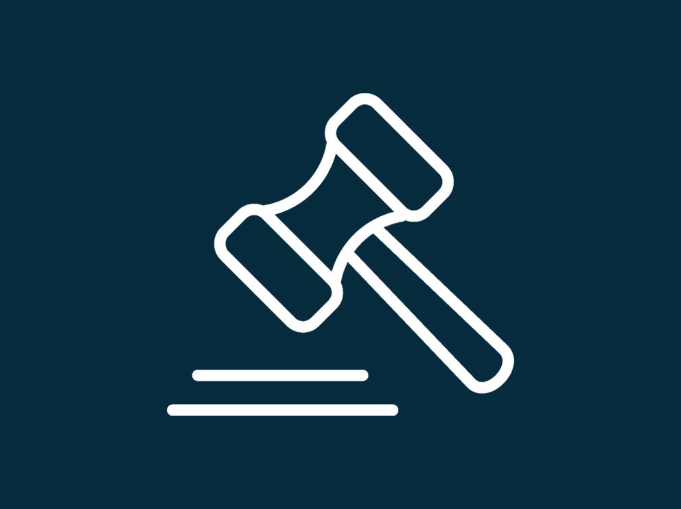 A white gavel on dark blue background