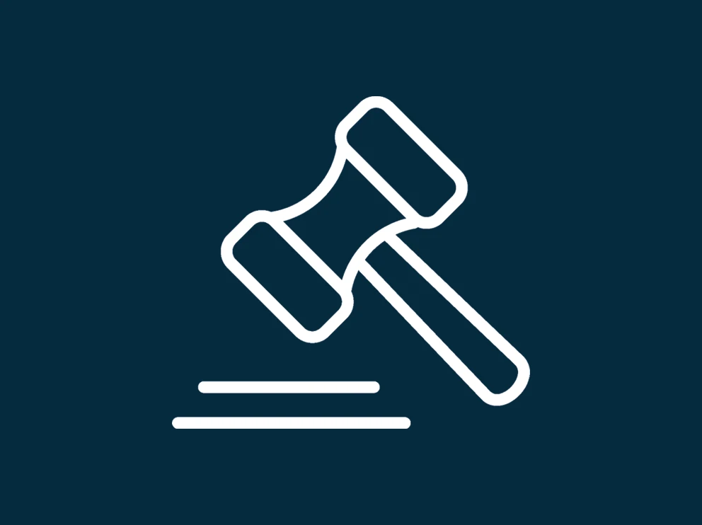 A white gavel on dark blue background