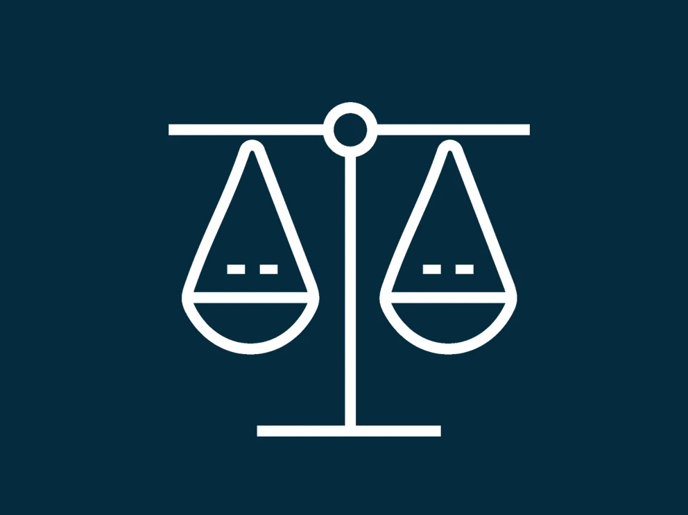 A white balanced scales icon on dark blue background 